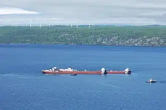 MV Roger Blough aground in Whitefish Bay with Prince Wind Farm in the background