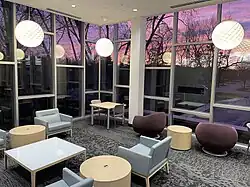 Reading room with tables, chairs, windows and sunset