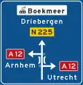 K5: Non-motorway advance information panel showing intermediary destinations, road numbers, a viaduct symbol and a sign for an industrial zone