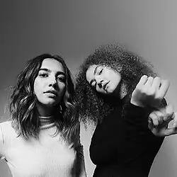 Black and white photograph of Ana and Vitória looking at the camera