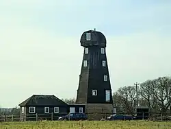 The reconstructed (without sails) smock windmill at Ockley, Surrey, England. February 2025