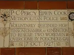 A tablet formed of five tiles of varying sizes, bordered by yellow and blue flowers in an art nouveau style