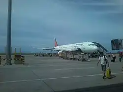 A PAL Express Airbus A321-200 is embarking passengers on a flight bound for Manila.