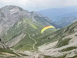 Paraglider taking off from summit