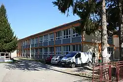 2 story building and various cars parked outside