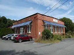 A brick powerhouse building with modern awnings and windows