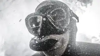 black-and-white close-up image of Craig Foster wearing a scuba mask