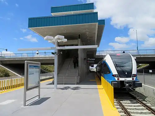 A railcar at a railway station in the center of a highway