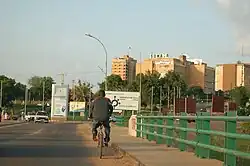 A few beige multi-storey buildings. The most visible building has a sign that says "SOMAIR"