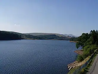 A lake surrounded by trees and hills