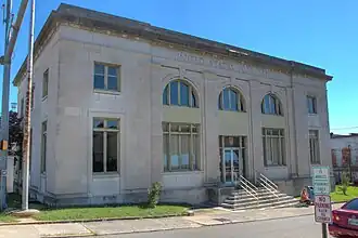 Two-story building fronted with staircase and arched windows