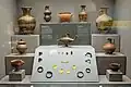 Display case of pottery and jewelry from the Protogeometric period