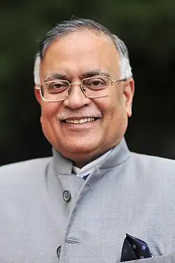 Head and shoulders portrait of Pradeep Kumar Kapur wearing Indian dress with pocket square.