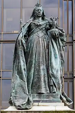 A statue of a crowned Queen Victoria, holding a scepter and orb.
