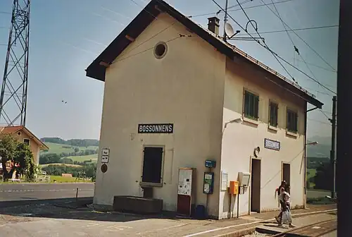 Two-story station building with platform and fountain