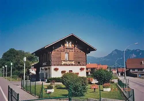 Two-story wooden station building with a station signage