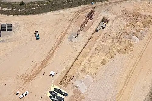 Slit trenches for the disposition of low-level waste