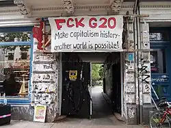 entrance with sign saying "Fuck G20"