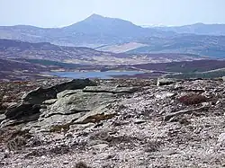 Schiehallion from Meall Dearg. Looking north-west from the stony plateau of Meall Dearg there is a good view of Schiehallion beyond Loch Hoil and the Tay valley.