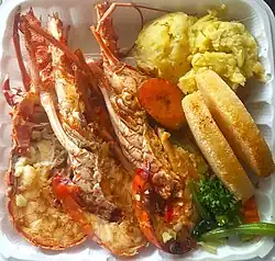 Garlic lobster with mashed sweet potato, stir-fry vegetables, fried bammy and ripe plantain.