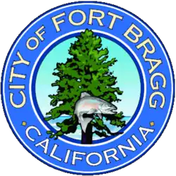 The city's official seal, in chief a salmon superimposed on a redwood tree, the Pacific Ocean set in relief, bordered by a blue circle with the words 'City of Fort Bragg California' appearing within the border in gold block letters