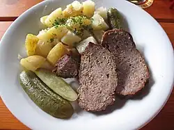 Meatloaf with potatoes and pickled cucumber