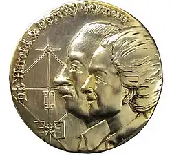 A bronze medal etched with the profile of a man and a woman, along with their names "Dr. Harold and Dorothy Seymour" and the outline of a baseball field.