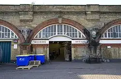 Site of the old station booking office; the bricked-up ticket windows are still visible