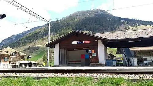 Shelter next to double-track railway line with mountain behind