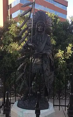 Bronze statue of a woman wearing traditional regalia for a chief