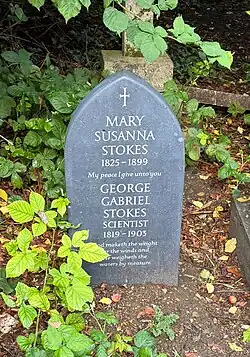 Replacement headstone for Sir George Stokes. It is made of slate and the inscription reads: MARY SUSANNA STOKES 1825-1899 My peace I give unto you GEORGE GABRIEL STOKES SCIENTIST 1819 - 1903 God maketh the weight for the winds and He weigheth the waters by measure