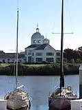 Suisun City Hall as seen across Suisun Slough between two boats in the harbor