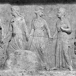 Three robed women walking