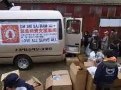The Sathya Sai Organization's emergency service truck carrying support relief items arriving at the disaster site.