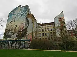 Large apartment block with a mural on one side