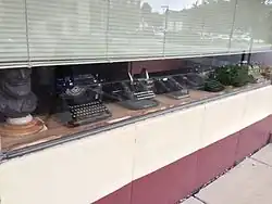 Typewriters in a Woodstock business' window in 2013. Note the name "Woodstock" on some of them.