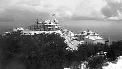 The Echo Mountain Promontory (ca. 1896) after a snowfall, and the White City resort of the Mount Lowe Railway as seen from a higher spot on the ridge and overlooking Altadena, CA. Buildings viewed from left to right: The Echo Chalet, Echo Mountain House, Incline Powerhouse, Dormitories, and Car Barn. Behind the car barn, note an inflatable reservoir for the storage of hydrogen gas produced in Pasadena and piped some 8.5 miles (13.7 km) to Echo. Echo Mountain is also known for its incredible echoes.