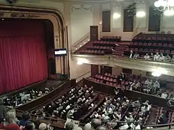 Auditorium with wrap-around balcony, and stage with orchestra pit