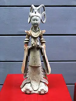 Fashionably-dressed female attendant of the early, slender, type